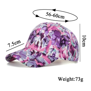 Floral print baseball cap with pink and gold glitter patterns and adjustable brim