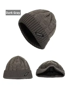 Detailed view of the dark grey knitted beanie with thick ribbed texture and warm fleece lining