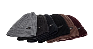 Detail view of five different colors of winter cable knit beanies with soft fleece lining