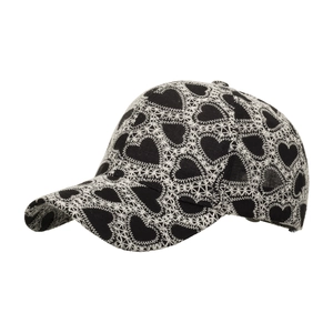 Black baseball cap with white heart embroidery and curved brim in side view