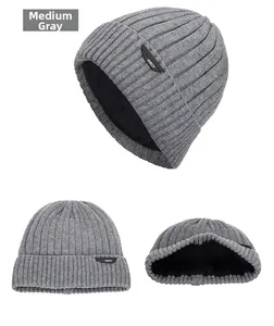 Detail view of dark grey knitted beanie showing thick ribbed texture and warm fleece lining