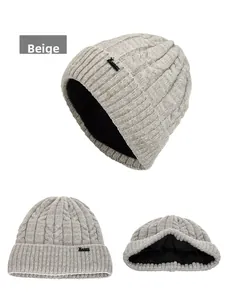 Detail view of beige cable knit beanie with thick black fleece lining for winter warmth