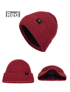 Detailed macro view showing the thick knitted texture and warm black fleece lining of the beanie