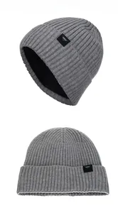 Detail of grey knitted winter beanie featuring ribbed texture and warm fleece lining