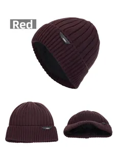 Detail view of red winter beanie with thick knit texture and soft fleece lining