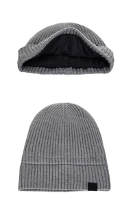 Detail of grey knitted beanie with warm black fleece lining and vertical stripe texture