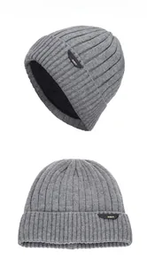 Detailed view of grey knitted beanie with vertical stripes and warm inner lining