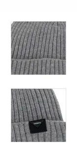 Detail of grey ribbed knit beanie showing thick texture and black XHBOY woven label
