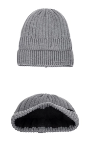 Detail view of grey ribbed knit beanie showing thick black fleece lining and vertical textures