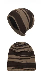 Close-up detail of striped knitted beanie with thick warm black fleece lining texture