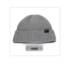 Close-up of light grey knit beanie showing vertical ribbing texture and black woven label