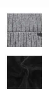 Detail of grey thick knit outer layer and black fleece lining for winter warmth