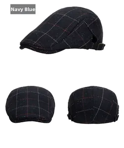 Detail view of navy blue herringbone flat cap with metal buckle and speckled wool fabric