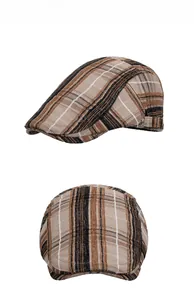 Detail view of brown plaid newsboy cap with classic checkered pattern and metal buckle