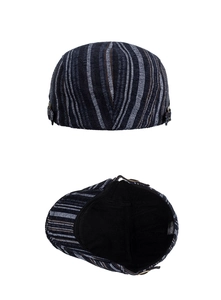 Detail of 100% cotton striped beret showing internal material label and metal buckle