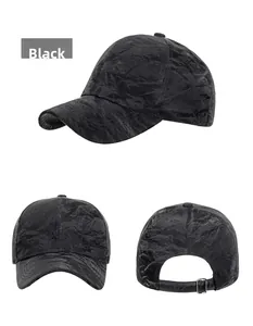 Close-up of black suede baseball cap with crinkle texture and adjustable metal buckle