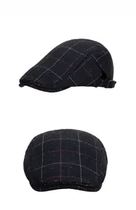 Detail view of navy herringbone ivy cap with plaid pattern and side metal buckle