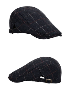 Detail of navy plaid wool ivy cap featuring bronze adjustable side buckle and twill texture