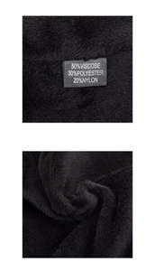 Close-up of the black knit fabric texture and material composition label for beanie