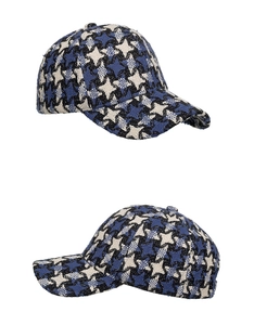 Close-up of woven tweed star pattern on baseball cap with detailed fabric texture