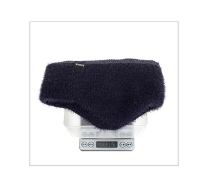 Detail showing the 136.4g weight of the winter knitted ear-flap hat on an electronic scale