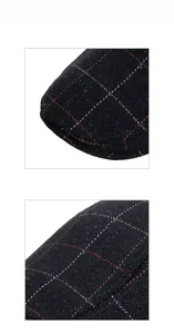 Macro detail of navy blue herringbone tweed fabric with orange plaid pattern on a beret hat