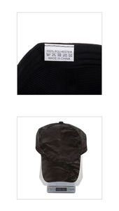 Detail showing inner wash label and weight measurement of black faux suede baseball cap