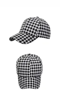 Macro side and top view of black and white plaid tweed texture on a baseball cap