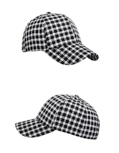Close-up of black and white plaid pattern on tweed baseball cap with high texture detail