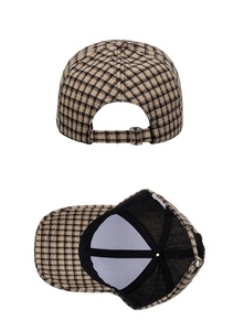 Detail view of the metal buckle adjustment and inner lining of the plaid baseball cap