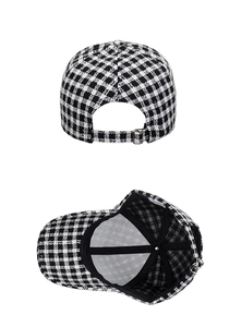 Detail view of plaid baseball cap showing metal adjustment buckle and black inner lining