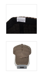 Detail view of plaid newsboy cap showing 100% polyester label and 106g weight on scale