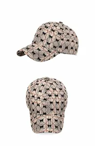 Vue détaillée de la casquette à carreaux avec motifs de nœuds floqués noirs et visière