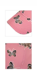 Dettaglio ravvicinato del cappellino rosa con motivo a farfalla e cuciture rinforzate