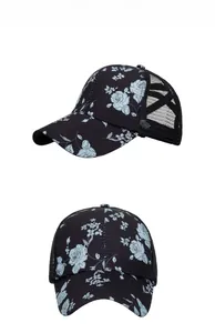 Detailed view of black baseball cap featuring light blue rose prints and breathable mesh back
