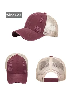 Detail view of wine red distressed baseball cap with mesh back and frayed brim accents