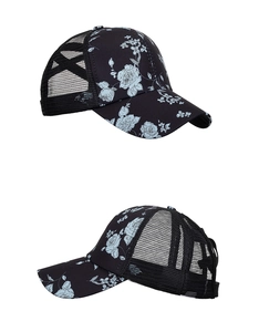 Detail view of black floral baseball cap with breathable mesh and ponytail cross band design