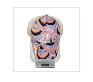 Detail showing colorful pattern baseball cap on scale weighing 64.9g with mesh back