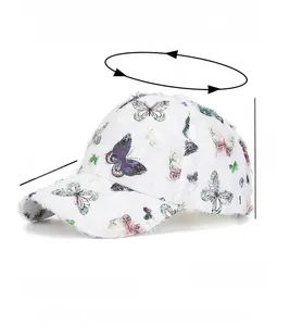 Detail view of ethnic white baseball cap with butterfly print and frayed edges texture