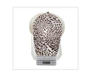 Detailed view of leopard print mesh baseball cap weighing 65.4g on a digital scale
