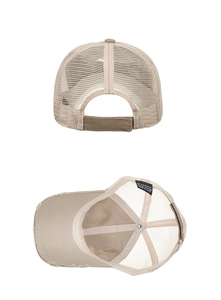 Detail view of washed mesh baseball cap featuring frayed edges and velcro strap closure