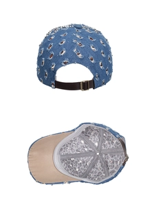 Detail view of distressed denim cap with silver studs and adjustable leather strap back