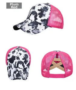 Detail of rose red mesh ponytail baseball cap with cow print and elastic cross back straps