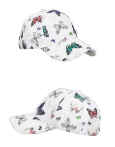 Close-up of white lace baseball cap featuring vibrant butterfly print and distressed texture