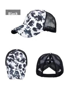 Detailed view of white cow print mesh baseball cap with ponytail criss-cross back
