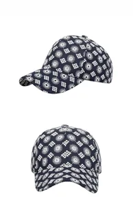 Detail view of navy blue baseball cap featuring intricate white geometric floral embroidery