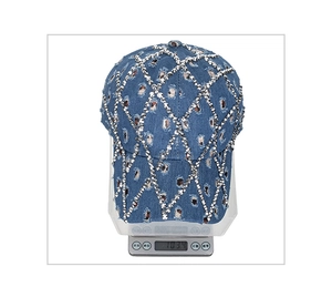 Front view of a distressed denim baseball cap with silver studs showing its weight of 103.4g