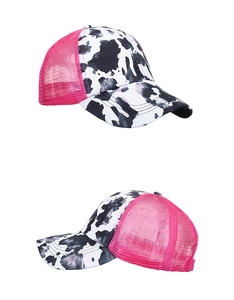 Detail view of cow print baseball cap with pink breathable mesh and ponytail opening