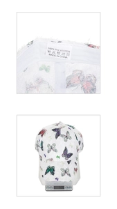 Detail of white butterfly print baseball cap showing 100% polyester label and 72.6g weight