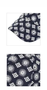 Detailed macro view of white floral embroidery on a navy blue cotton baseball cap